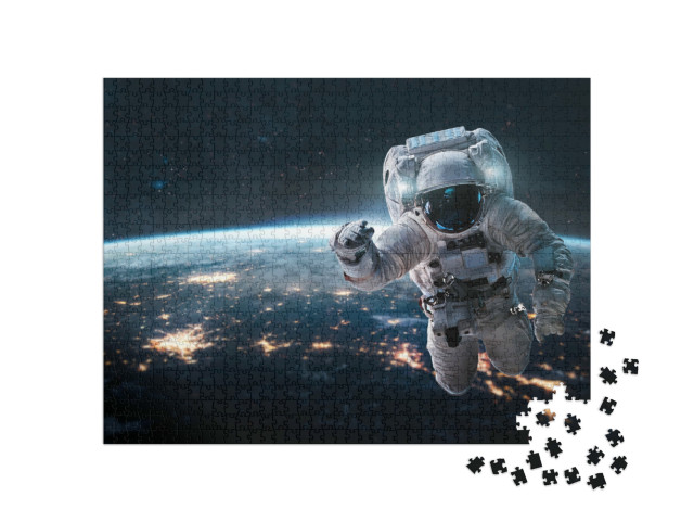 puzzle 1000 dílků „Astronaut se v noci vznáší nad Zemí“